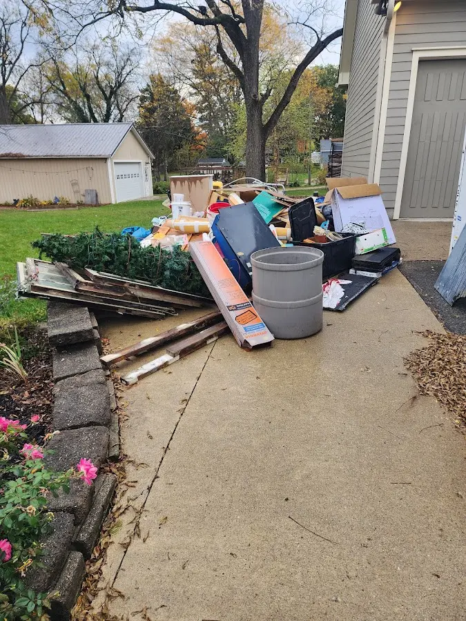 Dumpster being loaded with debris for Roofing Dumpster Rental in Prairie View